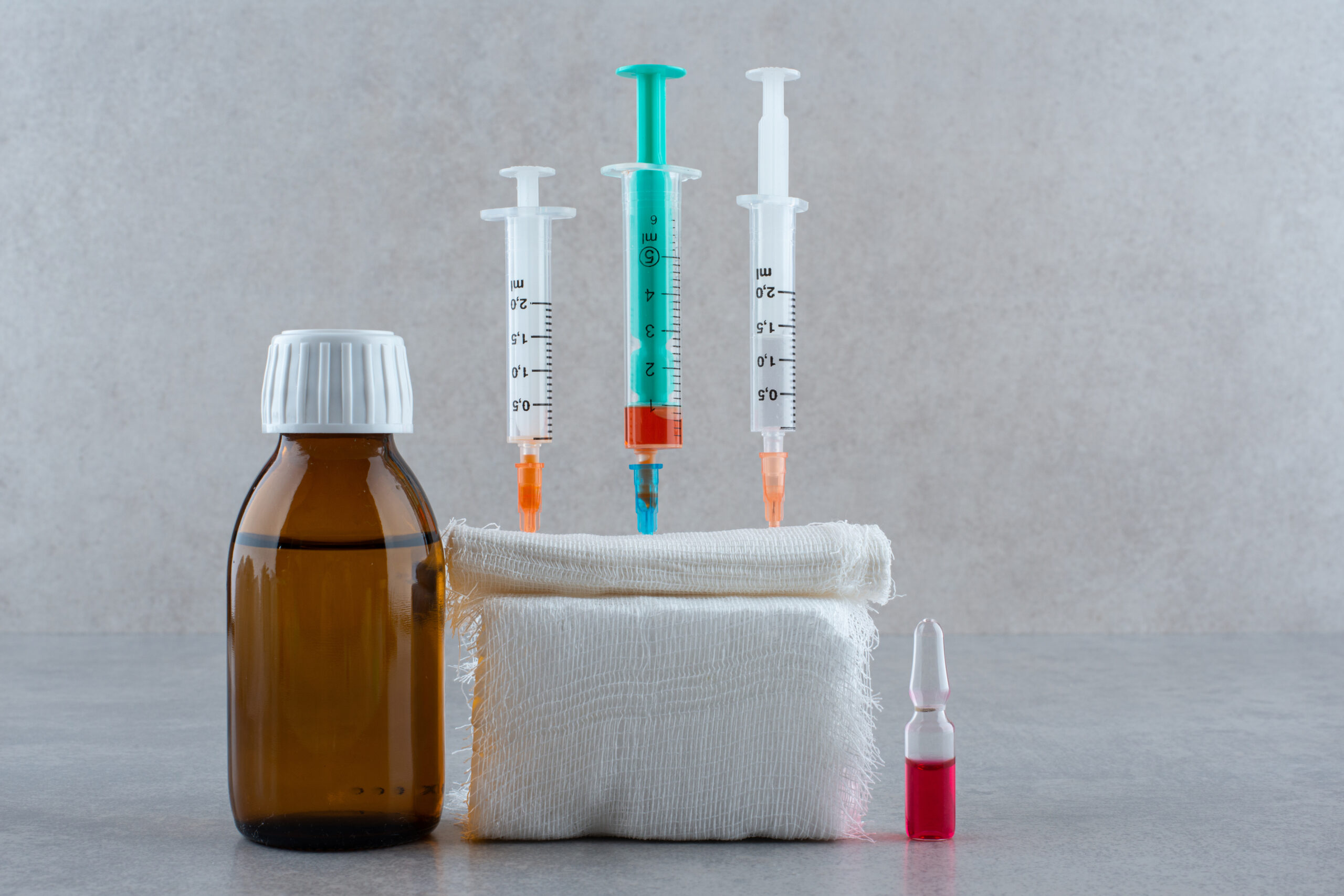 Medical ethanol with syringe on white background